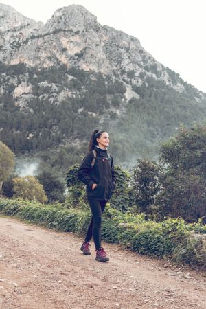 Female hiker walking near mountain