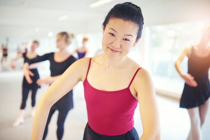Asian woman taking ballet class