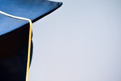 Back of head wearing graduation cap in studio shoot