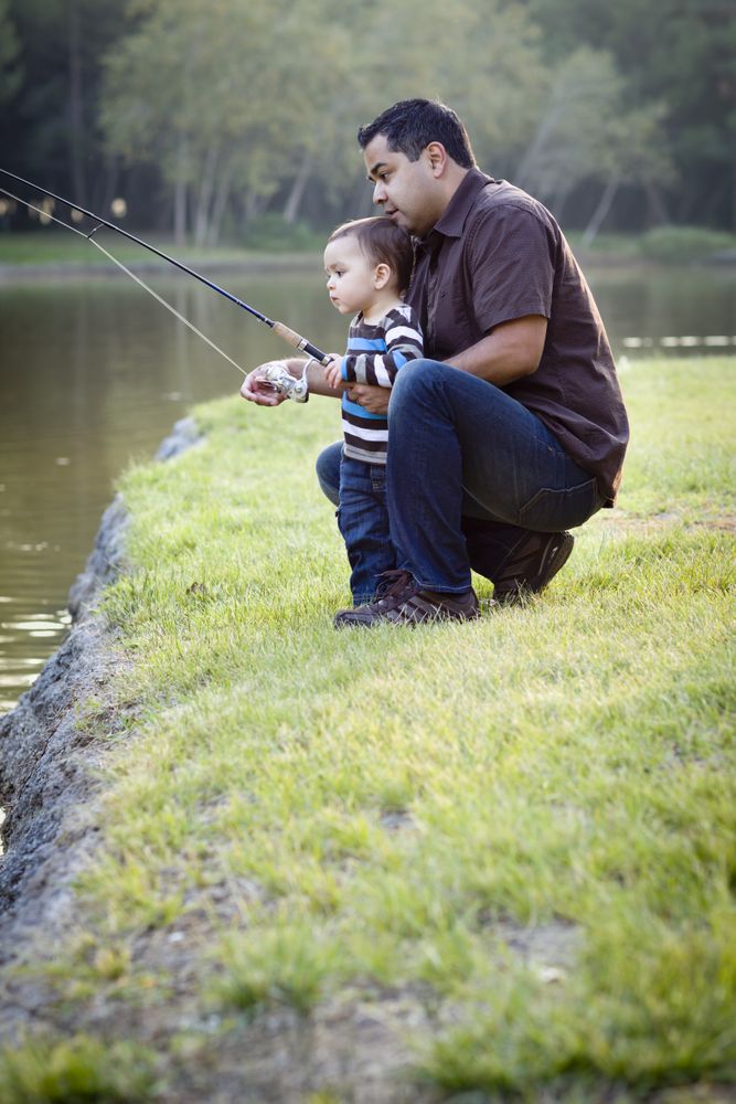 Happy Young Father and Son Fishing