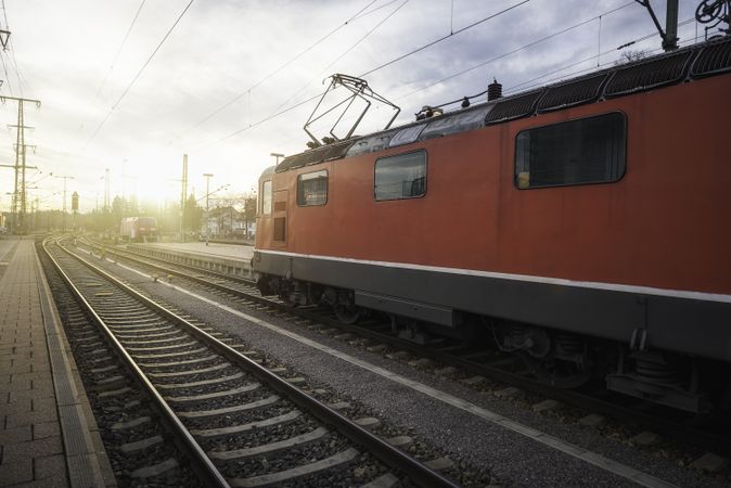 Red locomotive on railway tracks in german train station