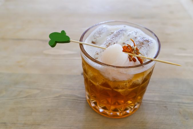 Lychee iced tea with with fresh lychee fruit in glass.