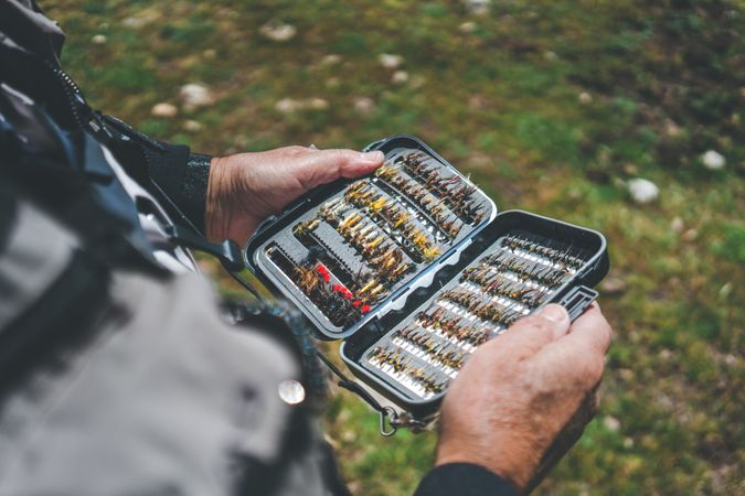 Fisherman demonstrating collection of baiting in box