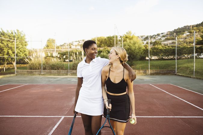 Two young women playing tennis