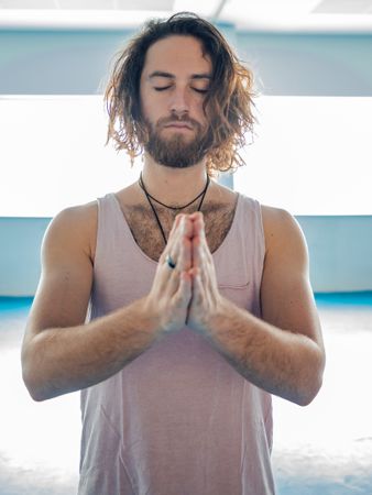 Male doing yoga in spacious room