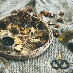 Basket of Christmas decorations on blanket