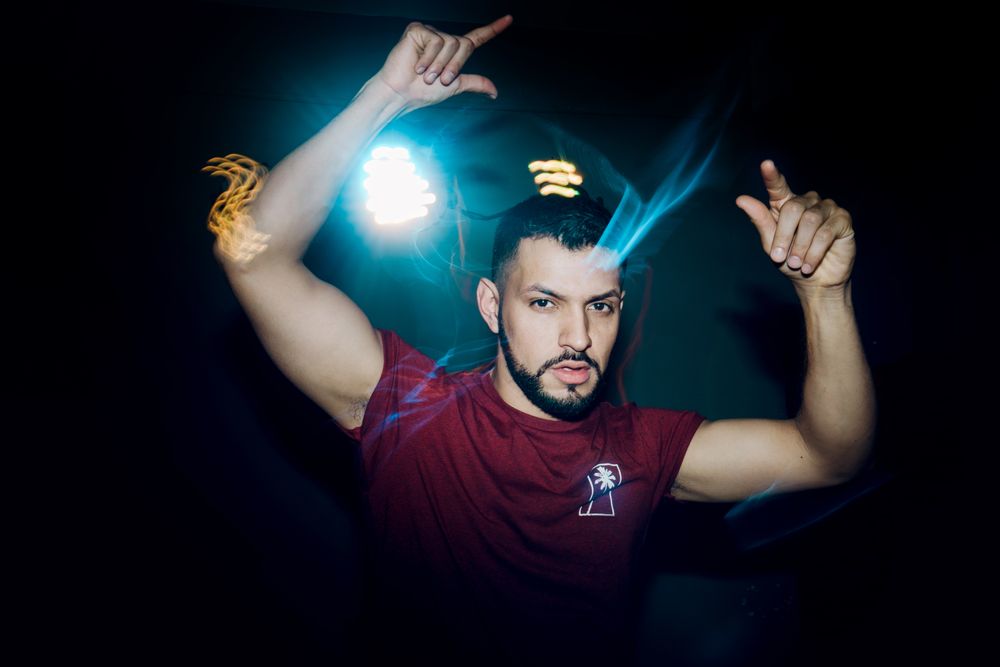 bearded man dancing in spotlight