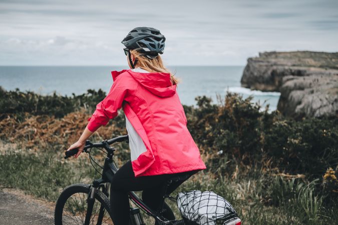 Female on bicycle enjoying landscape