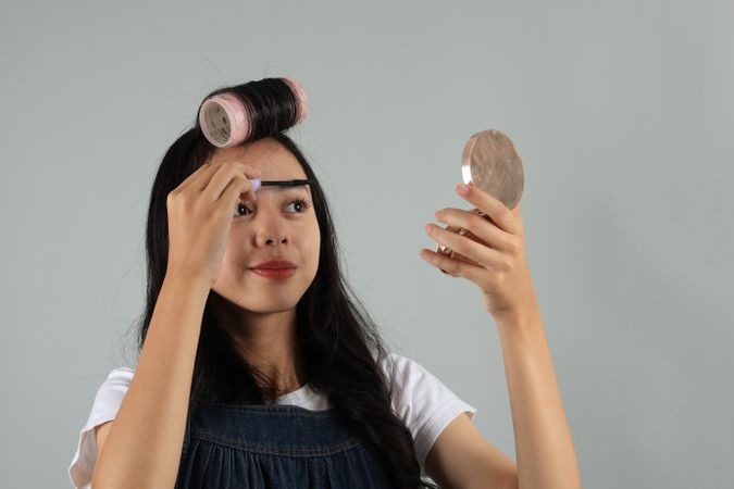 Young Asian Indonesian Girl Applying Mascara on Eyelashes