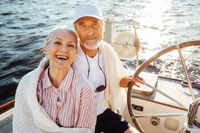 Content older couple sitting on boat on the water