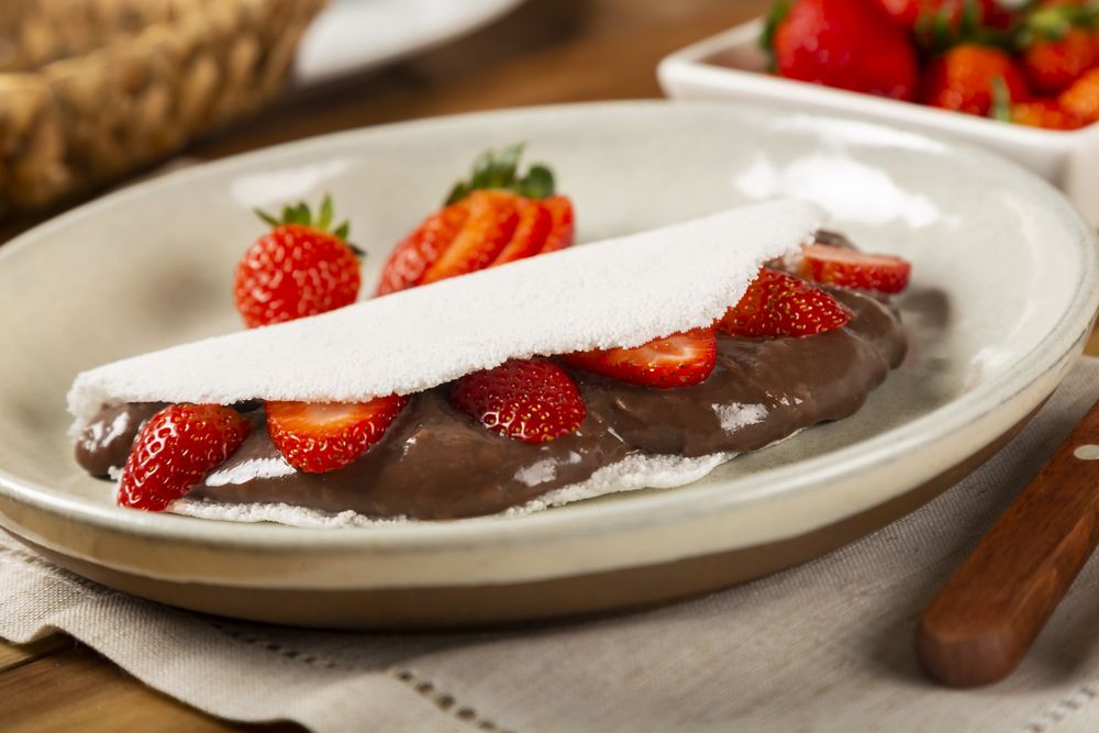 Sweet tapioca stuffed with chocolate and strawberry. Brazilian tapioca.