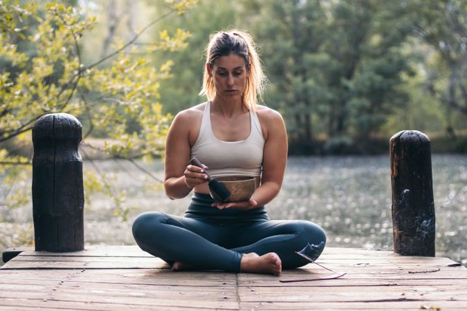 Young woman meditating and doing yoga in nature