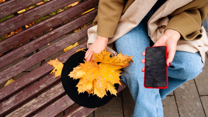 Woman on park bench in autumn