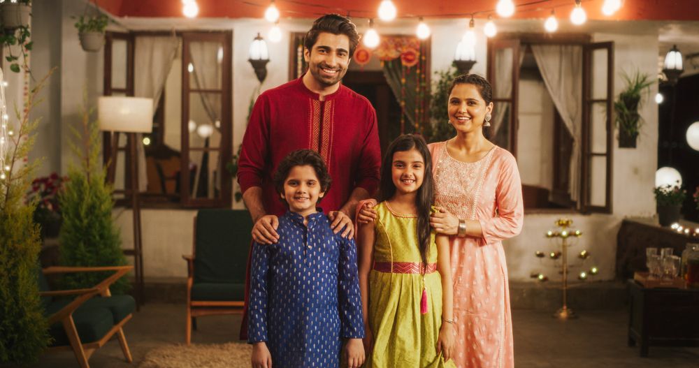 Portrait of Happy Indian Nuclear Family in Traditional Clothes Posing Together.
