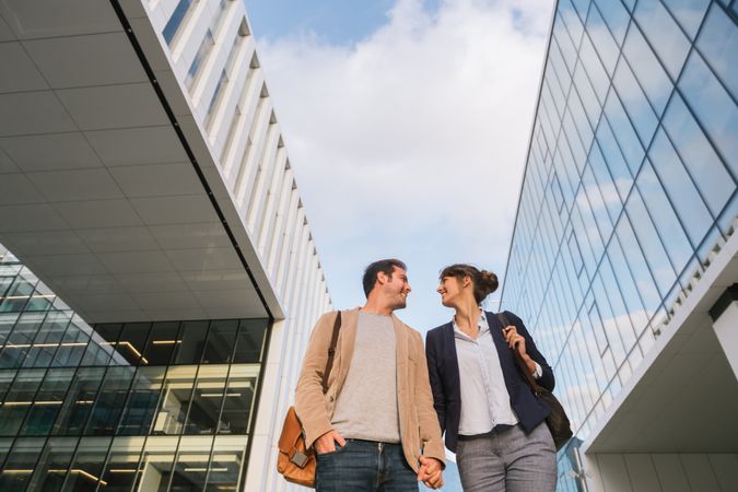 Businesspeople couple outside contemporary building