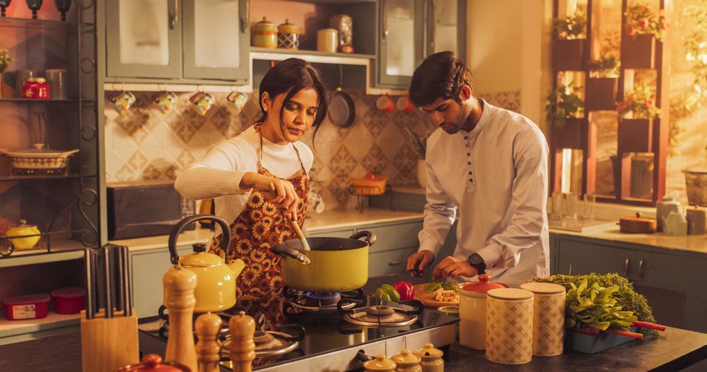 Charming Indian Couple Preparing Food Together: Laughing and Sharing Stories, Creating Delicious Meals