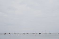 Yachts against overcast sky