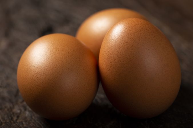 Brown chicken eggs rises on the table.