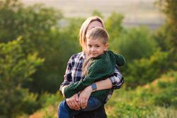 Happy mother and child at sunset together