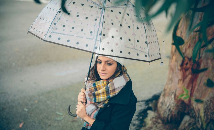 Woman walking with umbrella on rainy day