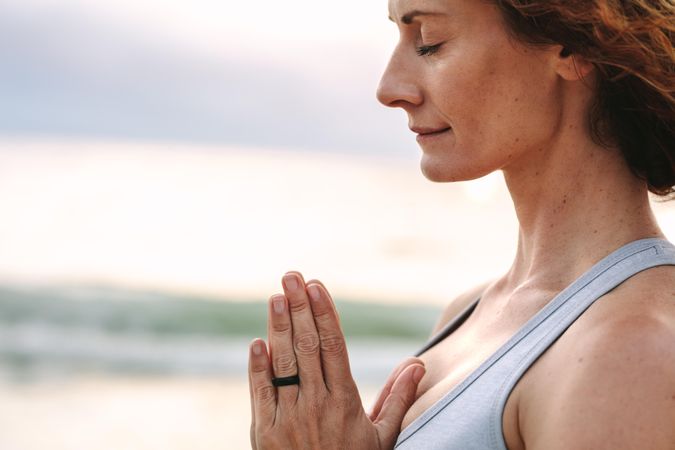 Close up of woman practicing yoga and meditation outdoors