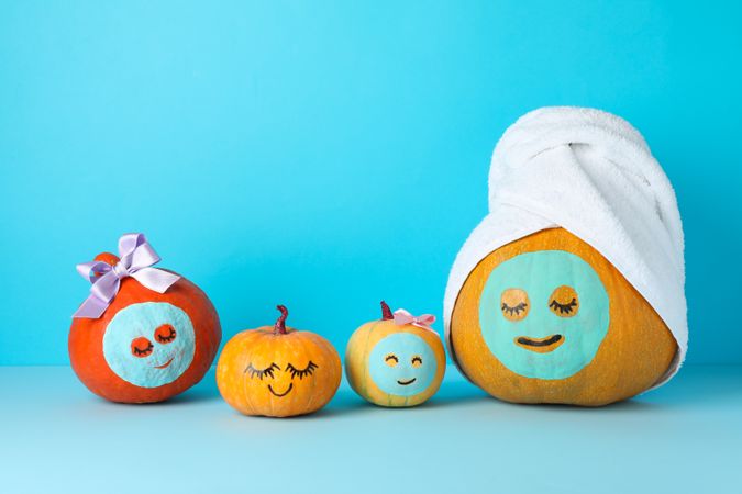 Funny pumpkins on blue background. Body care