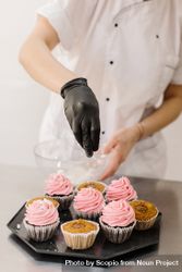 Chef adding sprinkles to cupcakes 41Al74