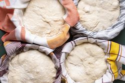 Top view of bread dough in bowls resting