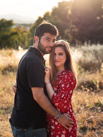 Young happy couple embracing in beautiful garden