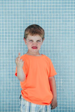 Cheerful playful boy showing sign of rock