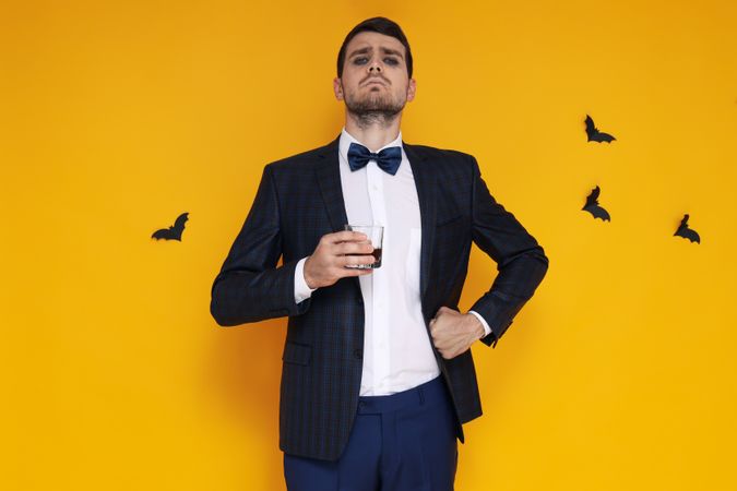 Concept of Halloween, young man on yellow background