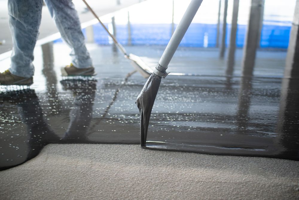 Crop unrecognizable people pouring concrete on floor