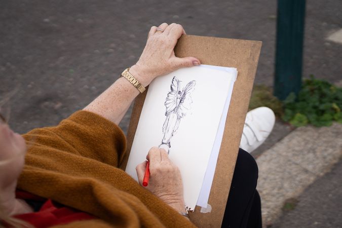 Looking down at easel of woman