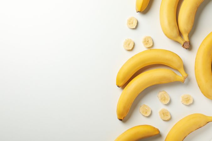 Bananas on bright background, top view. Fresh fruit