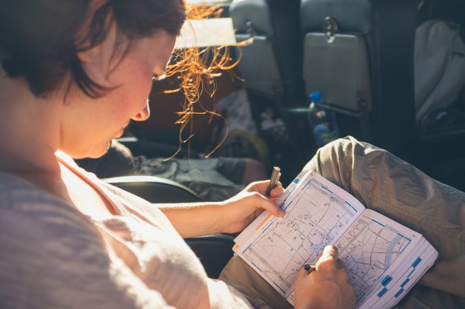 Traveler making notes on map