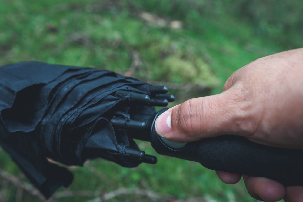 Hand pressing button on umbrella