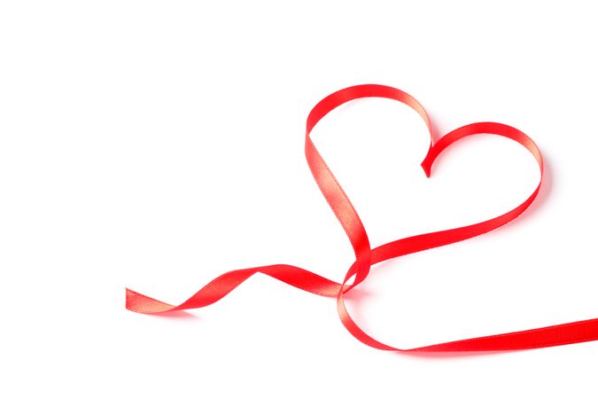 Red ribbon heart isolated on blank background