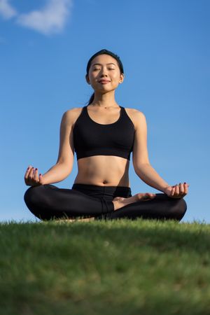 Woman meditating on the beach