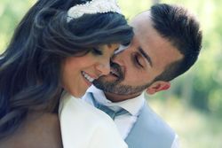 Close up of newlyweds being affectionate in forest