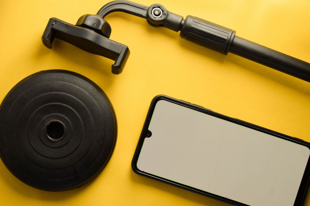 Mock up phone and dismantled stand on yellow background