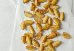 Potato wedges with salt on light background