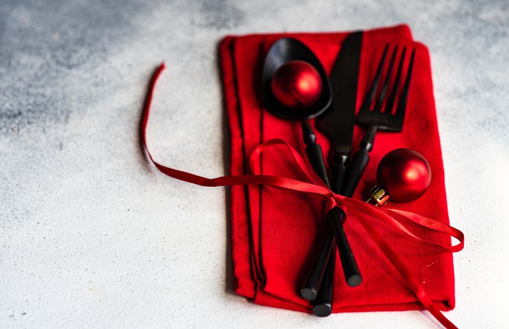 Christmas cutlery wrapped in red napkin and baubles