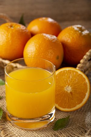 Glass with orange juice on the table.