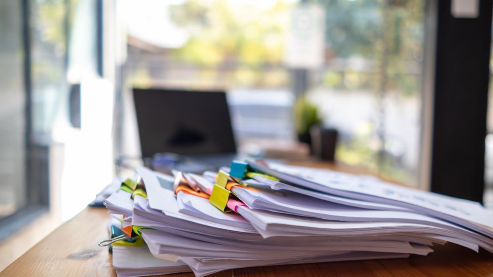 A huge stacked documents is an annual earnings summary document prepared for business