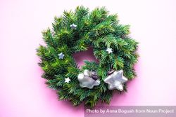 Christmas wreath with decorative stars on pink background 5Qq1e5