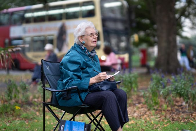 Woman sitting in park drawing