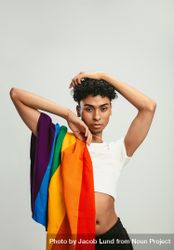 Man with a pride flag posing on light background 4ZJVx4