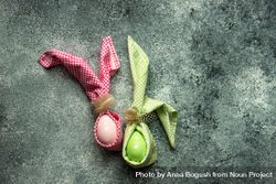 Pink & green egg decorations on grey counter bxAq6d