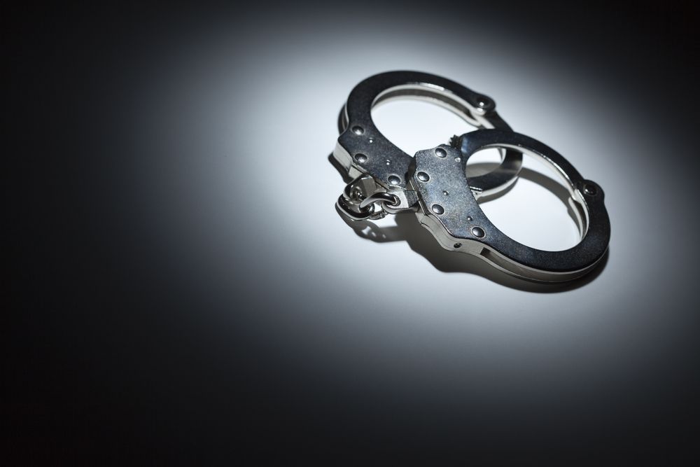 Abstract Pair of Handcuffs Under Spot Light - Text Room