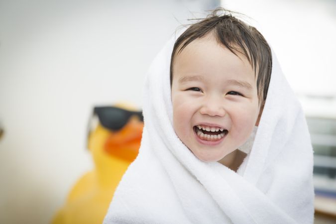 Happy Boy Wrapping In Towel at the Water Park